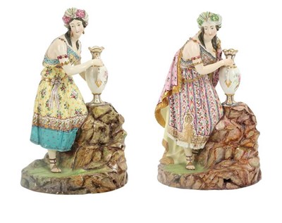 Lot 953 - TWO CONTINENTAL PORCELAIN FIGURES OF A COLOURFULLY-CLAD ODALISQUE WITH A VASE