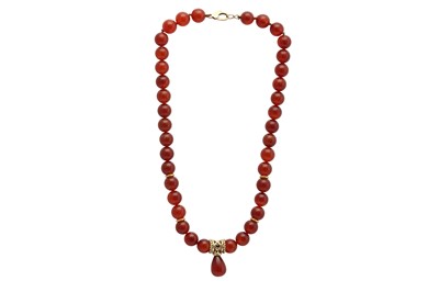 Lot 1281 - Kiki McDonough | A gold and carnelian necklace and a pair of earrings, 1993
