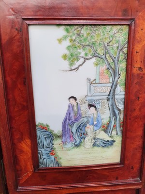 Lot 129 - A CHINESE FAMILLE ROSE BURLWOOD FOUR-FOLD SCREEN.