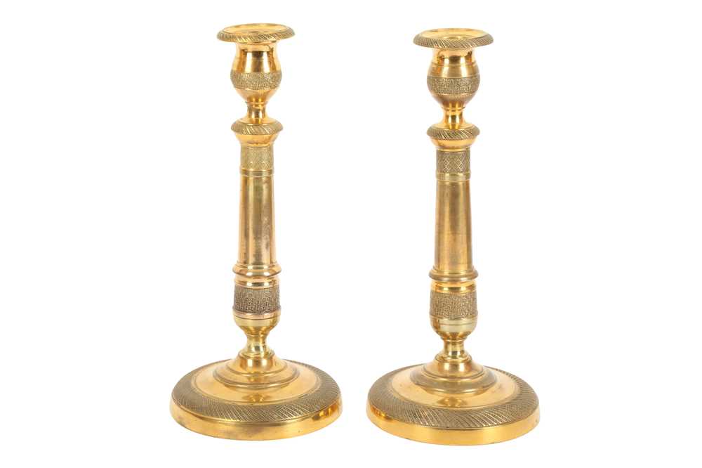 Lot 418 A pair of Empire gilt bronze candlesticks,
