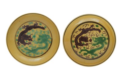 Lot 296 - A NEAR PAIR OF CHINESE YELLOW-GROUND GREEN AND AUBERGINE 'DRAGON' DISHES.