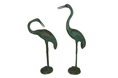 Lot 646 - A pair of green patinated bronze garden sculptures of cranes