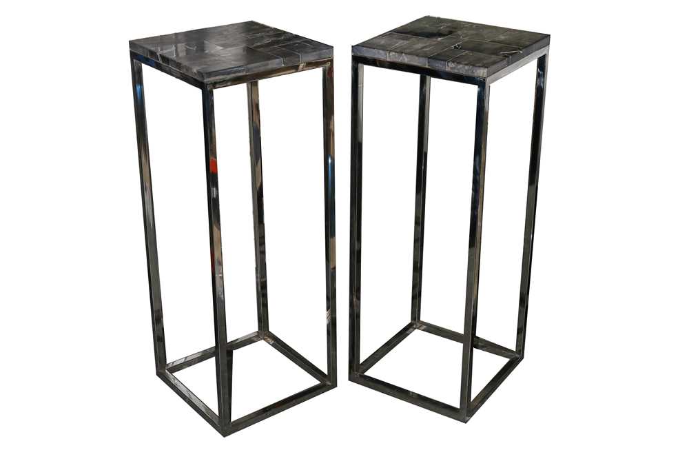 Lot 727 - A pair of 'Fast Black' side tables with petrified wood tops