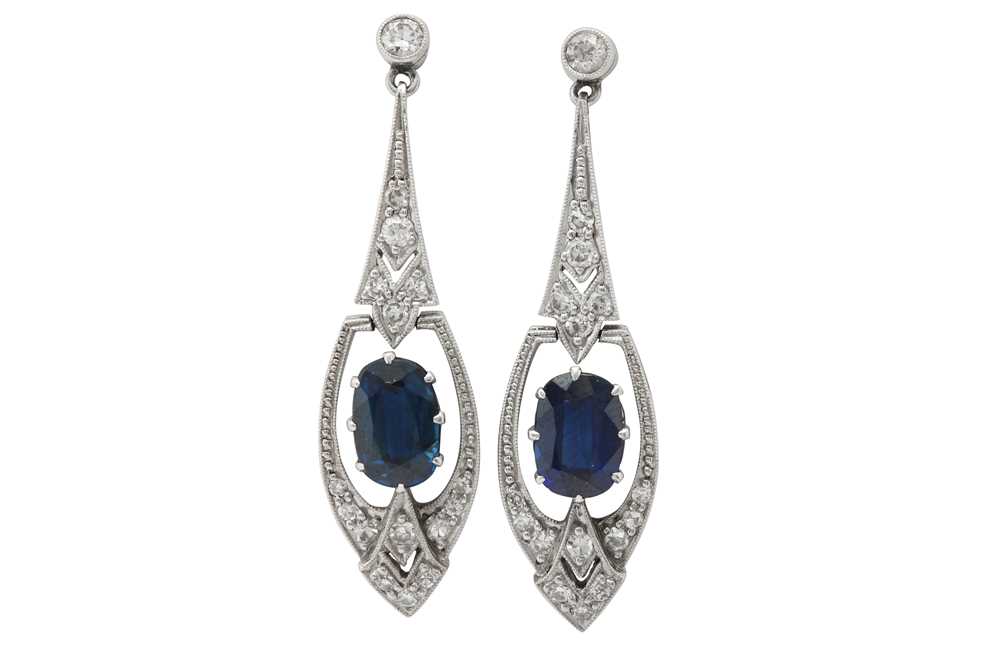 Lot 1318 - A pair of sapphire and diamond pendent earrings
