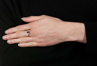 Lot 1298 - A purple spinel and diamond cluster ring