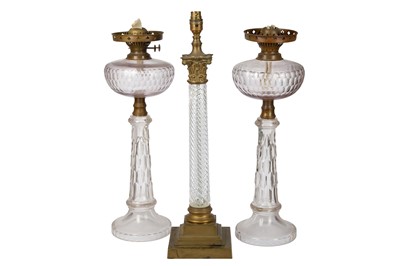 Lot 637 - A pair of late 19th century/early 20th century clear glass oil lamp bases