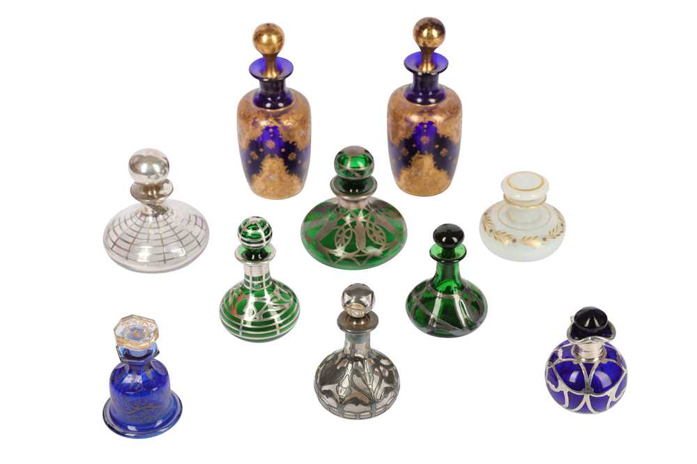 Lot 123 - A collection of six early 20th century glass and silvered metal perfume bottles with stoppers
