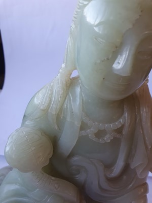 Lot 261 - A LARGE CHINESE PALE CELADON JADE FIGURE OF GUANYIN.