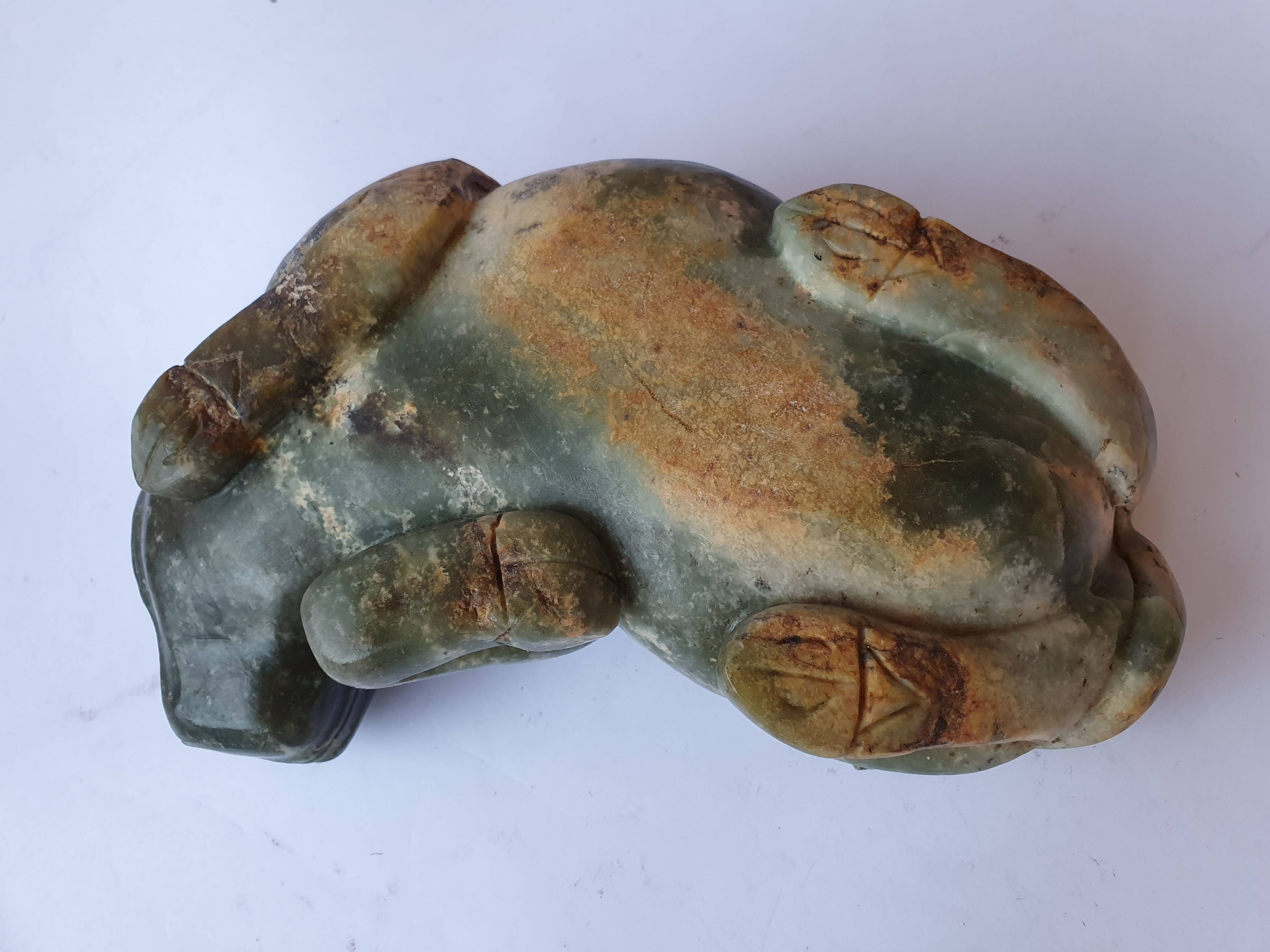 Lot 396 A CHINESE PALE CELADON JADE 'OX' CARVING.