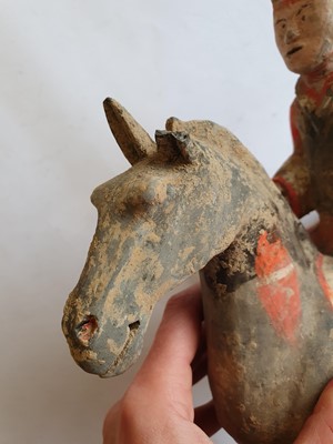 Lot 502 - A CHINESE POTTERY FIGURE OF A HORSERIDER.