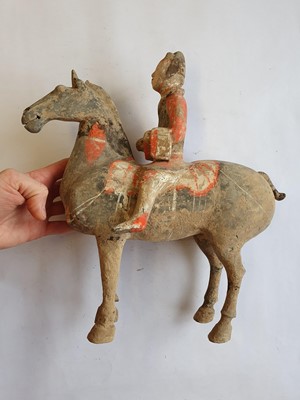 Lot 502 - A CHINESE POTTERY FIGURE OF A HORSERIDER.
