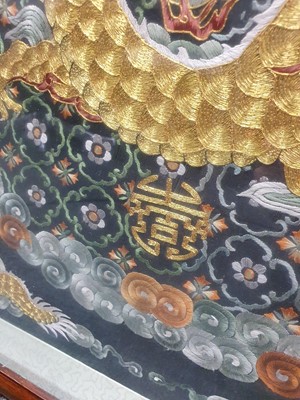 Lot 276 - A CHINESE SQUARE BLACK-GROND EMBROIDERED SILK 'DRAGON' PANEL.