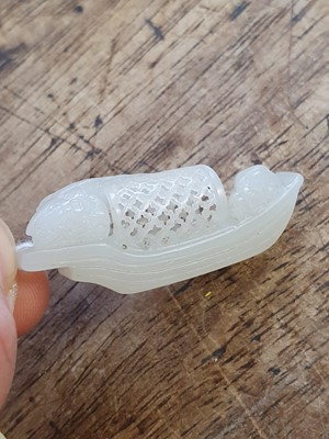 Lot 128 - A SMALL CHINESE WHITE JADE MODEL OF A BOAT.