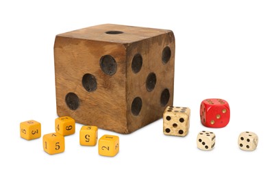 Lot 92 - AN OVER-SIZED CARVED AND STAINED WOODEN DICE TOGETHER WITH NINE OTHERS