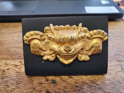 Lot 759 - A TIBETAN GILT-COPPER 'KIRTIMUKHA' PLAQUE.