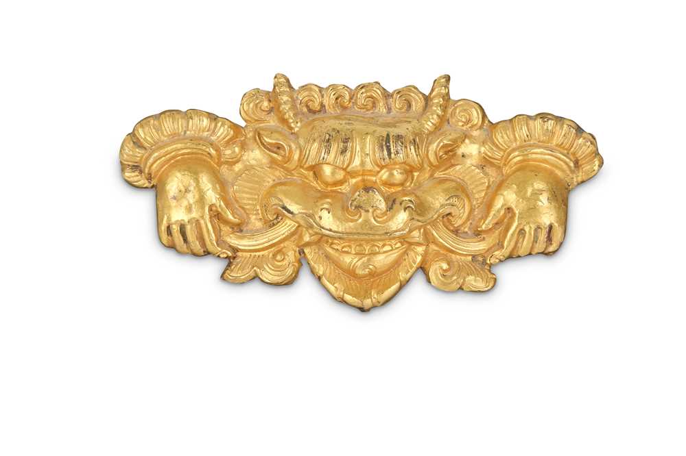 Lot 759 - A TIBETAN GILT-COPPER 'KIRTIMUKHA' PLAQUE.