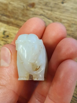 Lot 123 - A SMALL CHINESE WHITE JADE CARVING OF AN ELEPHANT.