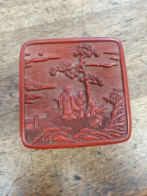 Lot 569 - A CHINESE CINNABAR LACQUER THREE-TIERED BOX AND COVER.