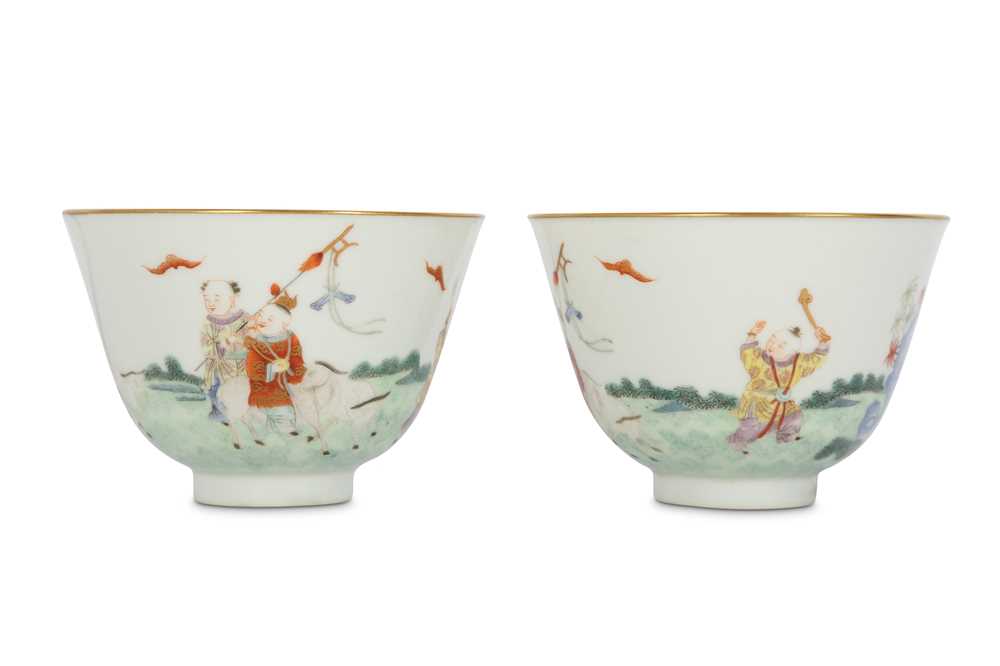 Lot 14 - A PAIR OF CHINESE FAMILLE ROSE 'NEW YEAR' CUPS.
