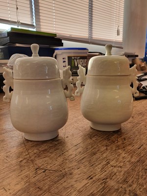 Lot 24 - A PAIR OF CHINESE WHITE-GLAZED ARCHAISTIC VASES AND COVERS.