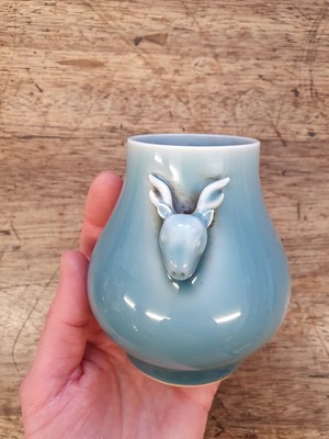 Lot 143 - A SMALL CHINESE PALE BLUE-GLAZED 'DEER' VASE, HU.