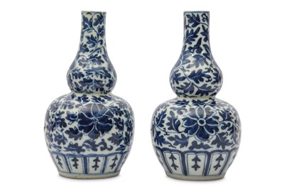 Lot 665 - A PAIR OF CHINESE BLUE AND WHITE 'DOUBLE GOURD' VASES.