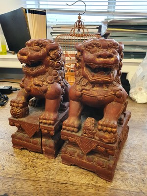 Lot 397 - A PAIR OF CHINESE RGILT-LACQUER LION DOGS.