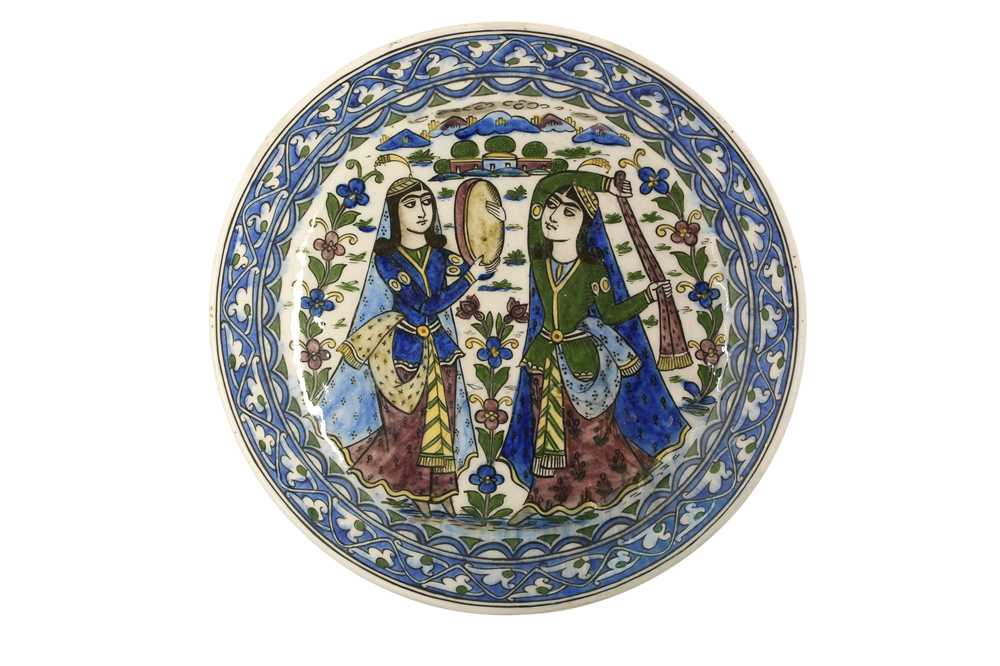 Lot 74 - A POLYCHROME-PAINTED POTTERY CHARGER FEATURING A FEMALE MUSICIAN AND DANCER