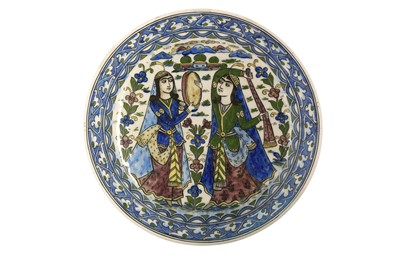 Lot 74 - A POLYCHROME-PAINTED POTTERY CHARGER FEATURING A FEMALE MUSICIAN AND DANCER