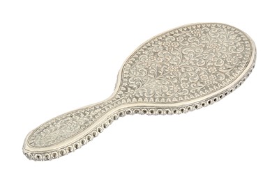Lot 160 - A KUTCH REPOUSSÉ AND CHASED SILVER HAND-HELD MIRROR