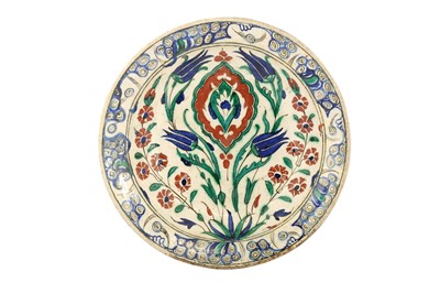 Lot 61 - AN IZNIK POTTERY DISH WITH ARABESQUE AND FLORAL DECORATION