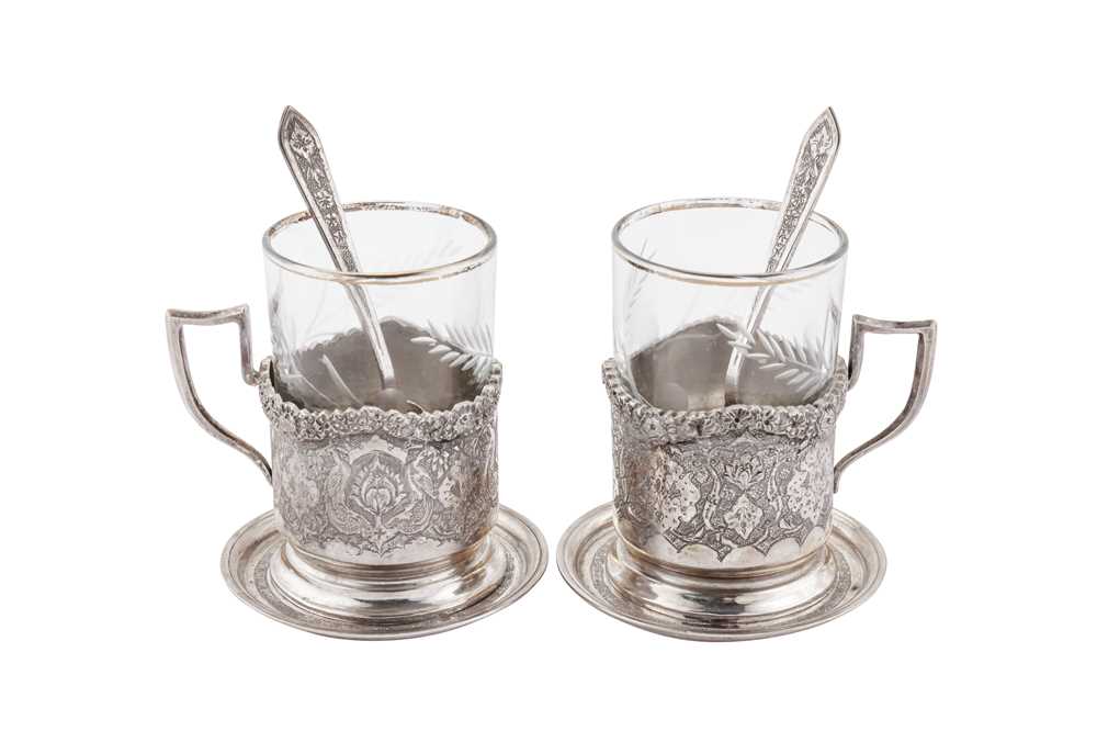 Lot 244 - A pair of mid-20th century Iranian (Persian) silver tea glass holders, coasters and spoons, Isfahan circa 1960