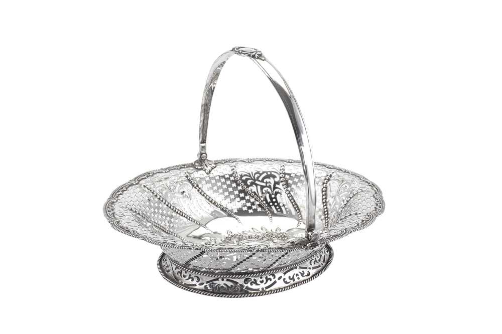 Lot 382 - A George III sterling silver cake or bread basket, London 1769 by William Plummer (reg. 8th April 1755)