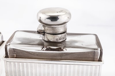 Lot 70 - A pair of Edwardian/George V Art Deco sterling silver mounted glass cologne or scent bottles, London 1907/12 by Samuel Jacob