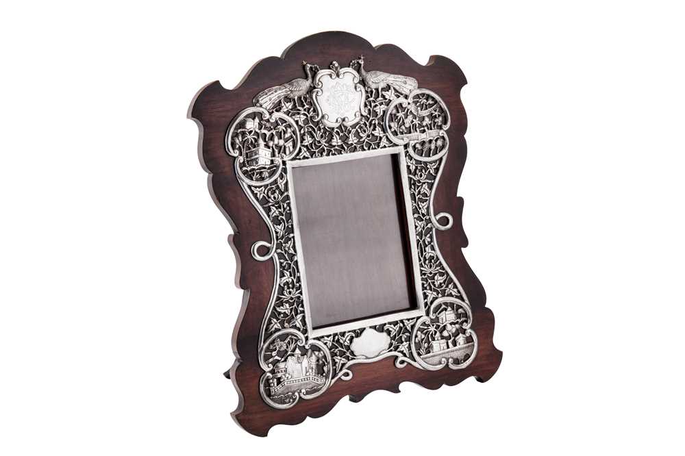 Lot 158 - An early 20th century Anglo – Indian unmarked silver mounted padouk wood dressing table mirror or photograph frame, probably Bombay circa 1910