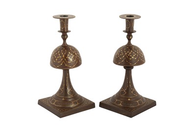 Lot 240 - A PAIR OF QAJAR GOLD-DAMASCENED STEEL CANDLESTICKS