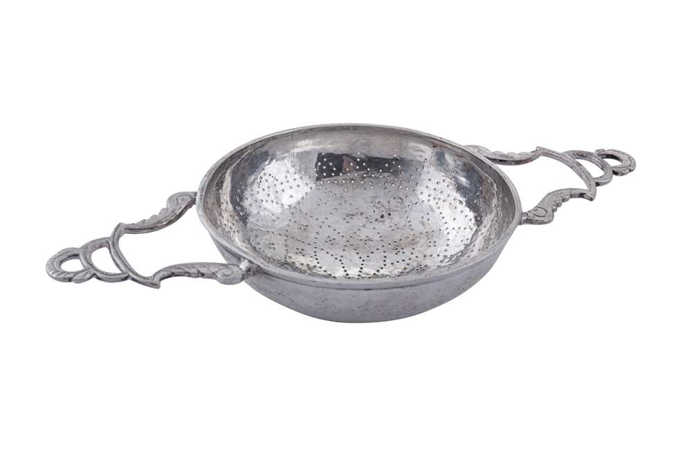 Lot 442 - An early 18th century unmarked silver lemon strainer, probably English circa 1730
