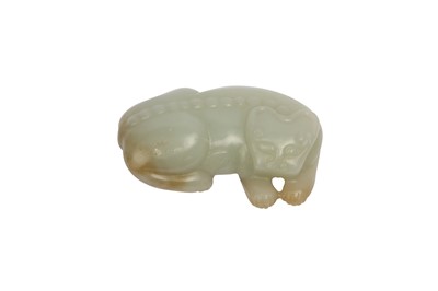 Lot 619 - A CHINESE PALE CELADON JADE ARCHAISTIC MODEL OF A LION. / A PALE CELEDON JADE CARVING OF A LION.