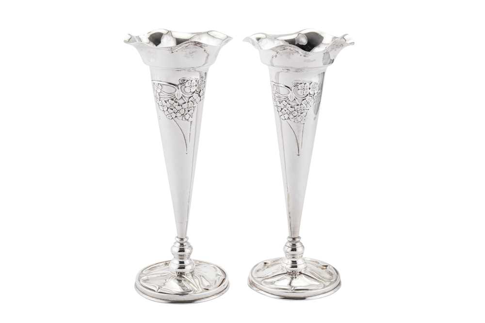 Lot 260 - A pair of Edwardian 'Arts and Crafts' sterling silver flower vases, Birmingham 1902, marked for William Hutton and Son, the design attributed to Kate Harris (active circa 1899-1905)