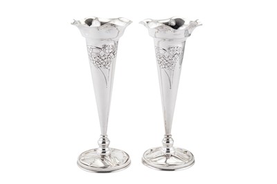 Lot 260 - A pair of Edwardian 'Arts and Crafts' sterling silver flower vases, Birmingham 1902, marked for William Hutton and Son, the design attributed to Kate Harris (active circa 1899-1905)