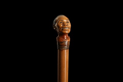 Lot 342 - A LATE 19TH CENTURY MALACCA WALKING CANE CARVED WITH THE HEAD OF A MAN