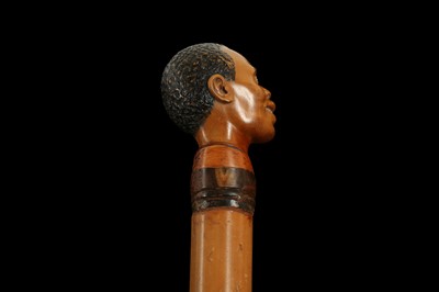 Lot 342 - A LATE 19TH CENTURY MALACCA WALKING CANE CARVED WITH THE HEAD OF A MAN