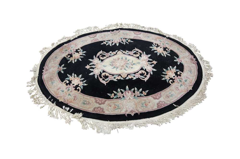 Lot 63 - A CHINESE OVAL WOOL RUG, 20TH CENTURY