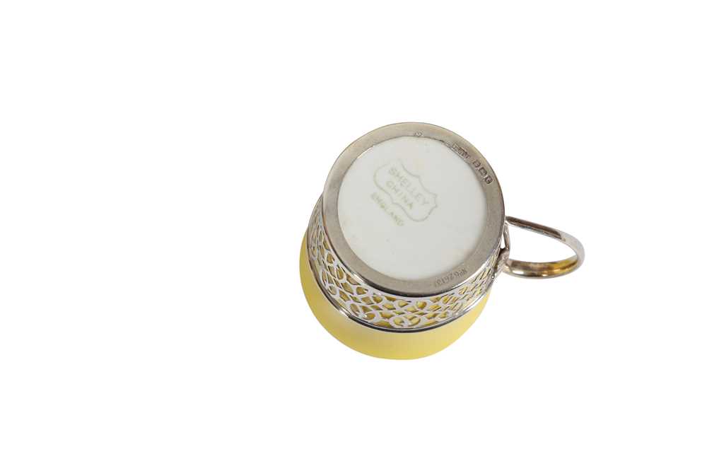 Lot 375 A SHELLEY YELLOW GLAZED PORCELAIN AND SILVER