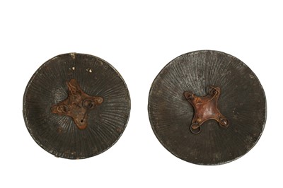 Lot 136 - A PAIR OF TRIBAL INDIAN CEREMONIAL SHIELDS WITH BRASS BOSSES
