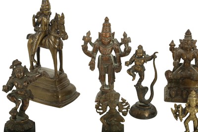 Lot 226 - A GROUP OF FOURTEEN BRONZE DEVOTIONAL MINIATURE ICONS (MURTI) AND A TEMPLE BELL