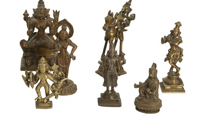 Lot 226 - A GROUP OF FOURTEEN BRONZE DEVOTIONAL MINIATURE ICONS (MURTI) AND A TEMPLE BELL