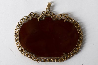 Lot 694 - AN ENGRAVED CARNELIAN PENDANT