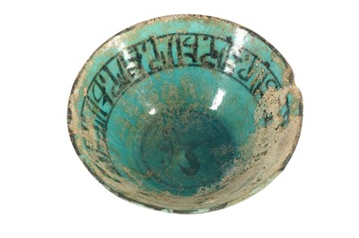 Lot 691 - A BLACK-PAINTED AND TURQUOISE-GLAZED POTTERY BOWL