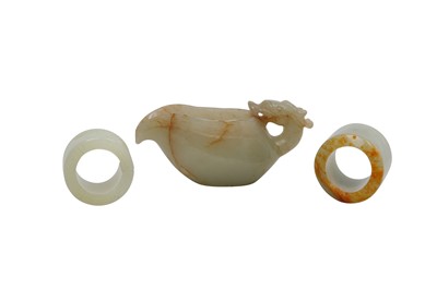 Lot 747 - A CHINESE PALE CELADON POURING VESSEL AND TWO ARCHER'S RINGS.